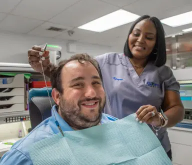 Smiling dental patient with dental implants