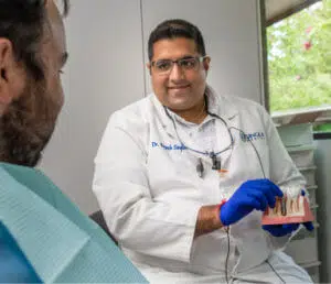 dentist showing patient dental implants in duncanville tx