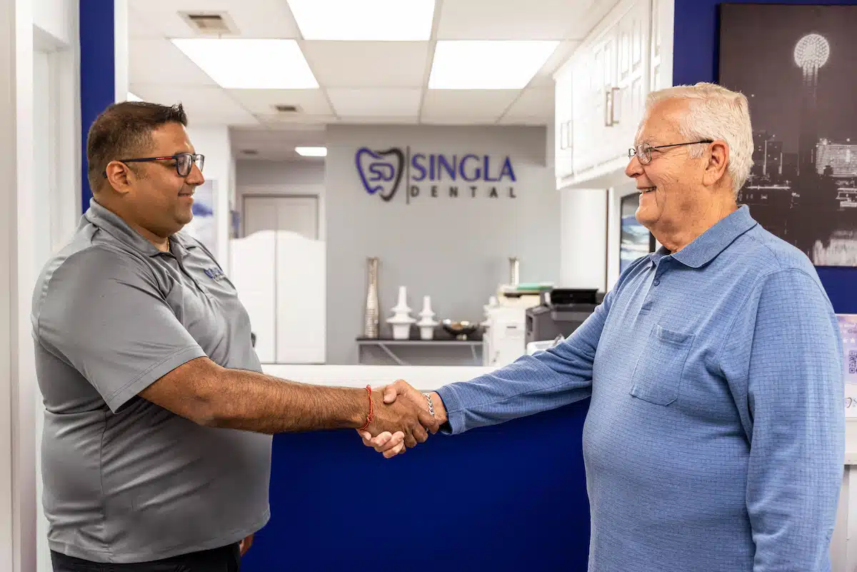 Dr. Rupesh Singla shaking hands with patient at Singla Dental with dentist in Duncanville,TX