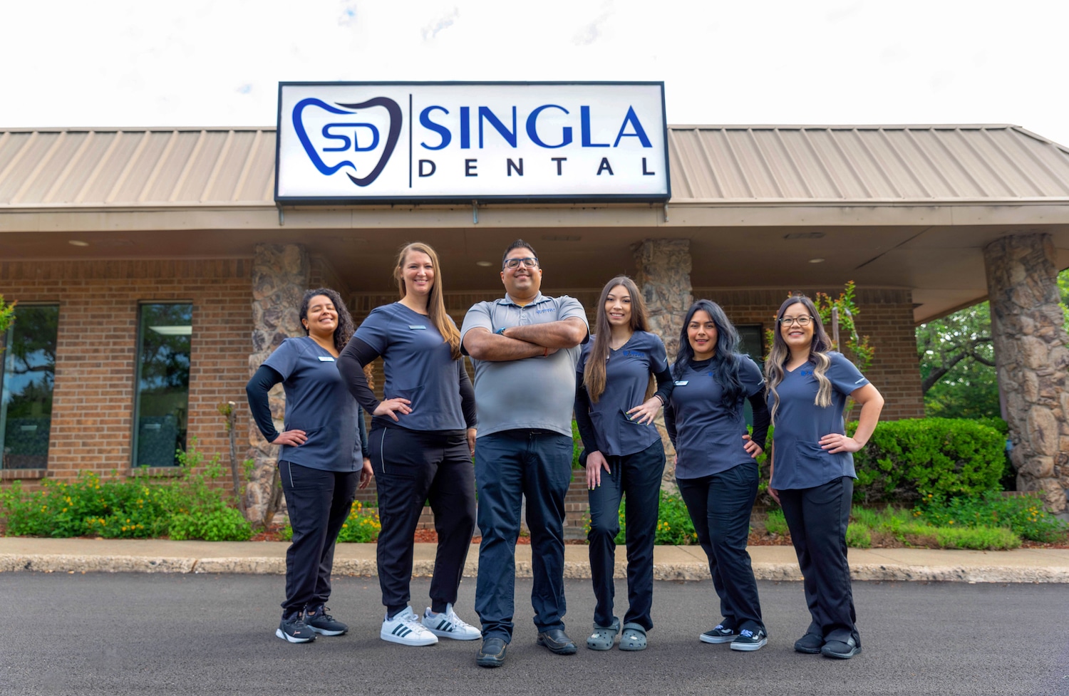 Singla Dental Team smiling in front of the practice in Duncanville,TX
