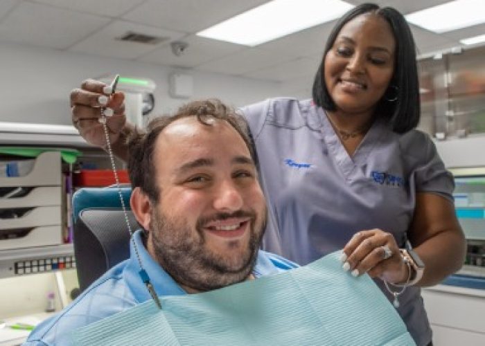 Smiling dental patient with dental implants